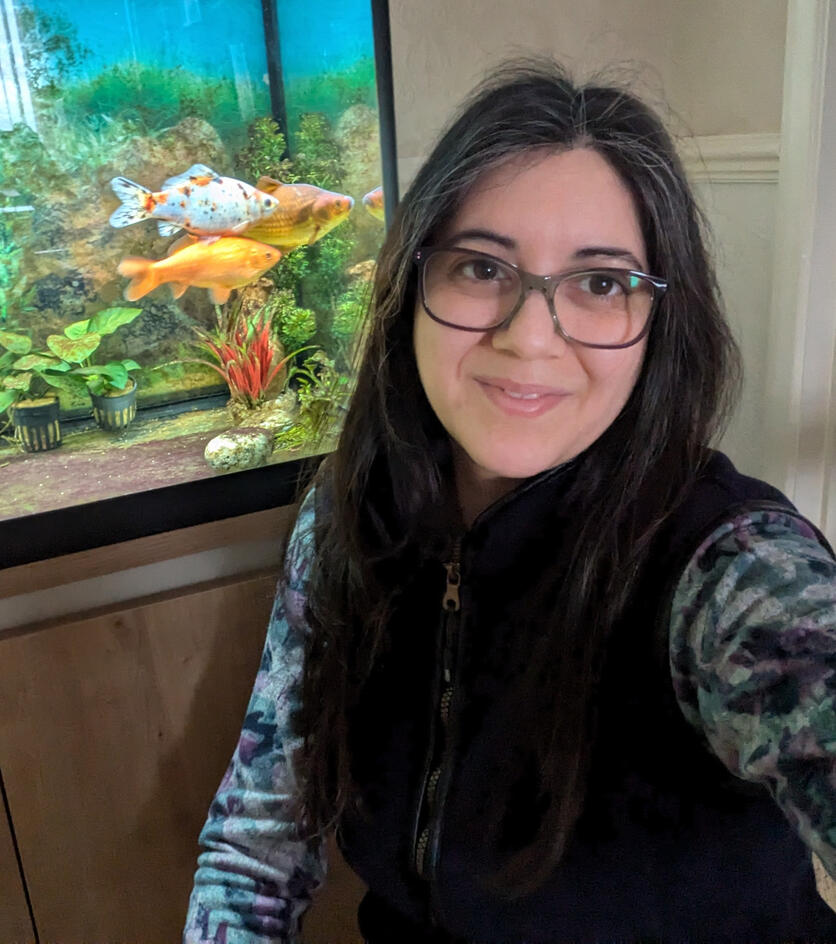 Photo of Becky in front of a goldfish tank